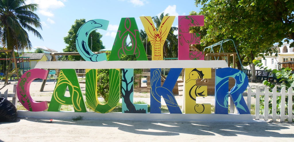 Caye Caulker sign in big letters on the beach